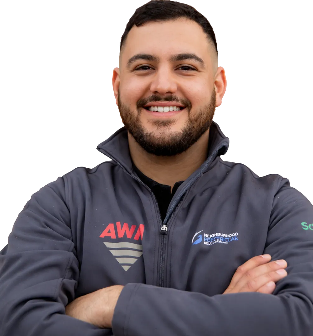 Smiling person in branded jacket, arms crossed.